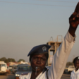 A female traffic officer directing motorists.